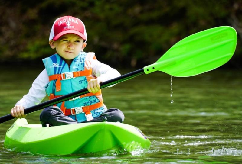 A little boy kayaking on Griffy Lake