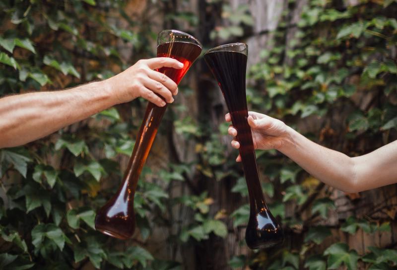 Two people cheers-ing yards of beer from The Irish Lion