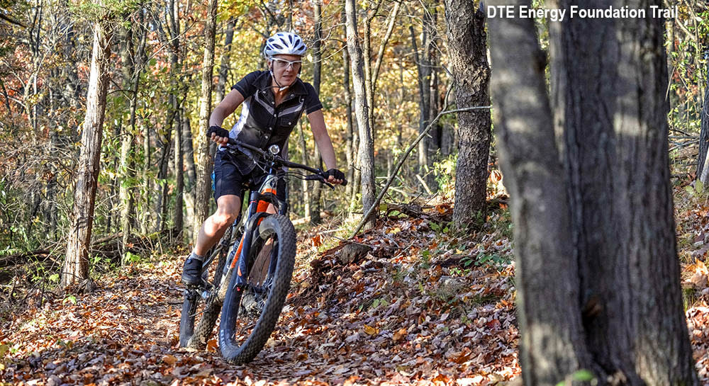 Woman mountain biking in the fall