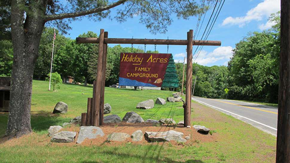 wooden sign woods trees grass