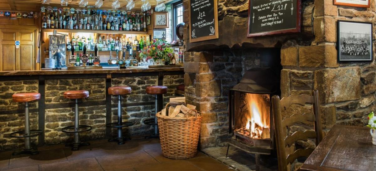 Bar with log fire at The Acorn Inn, Dorset