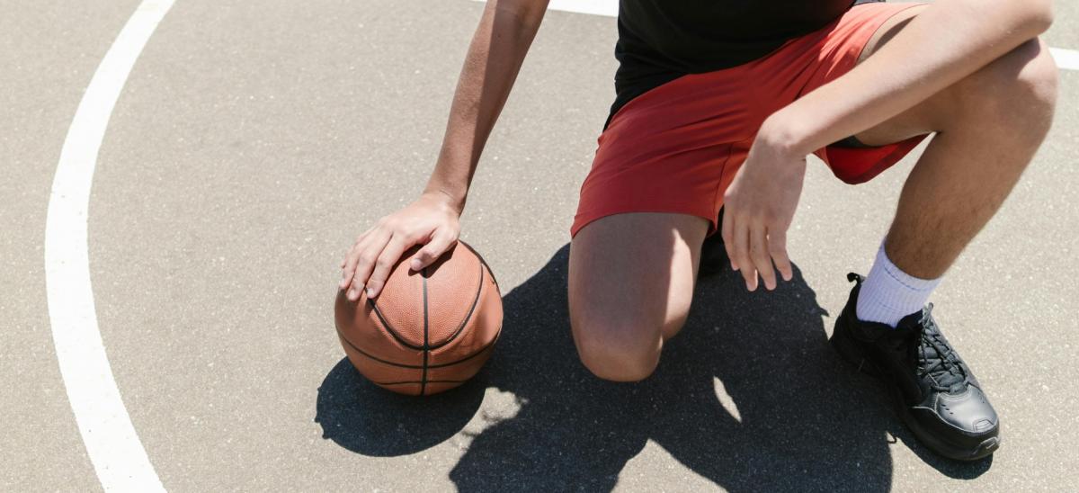 Tennage boy playing basketball