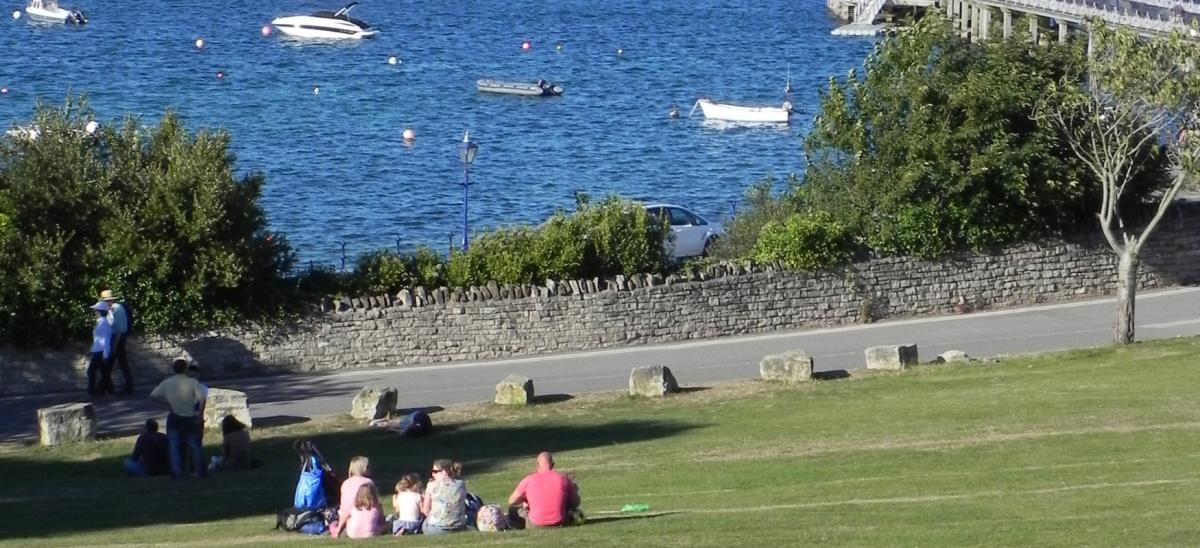 A family having a picnic at Prince Albert Gardens in Swanage, Dorset