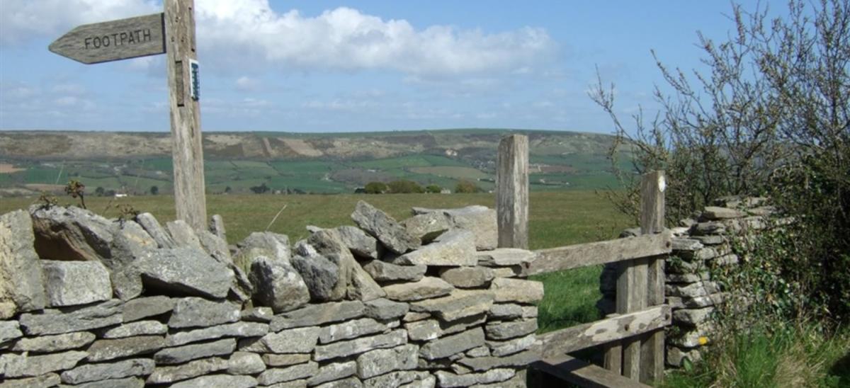 Stile and wooden signpost on the Quarrymans' Ways walking route