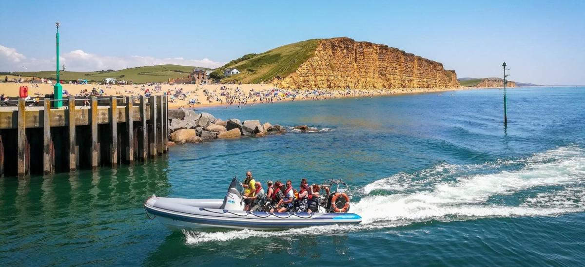 Passengers on board a Lyme Bay RIB Charter inflatable boat at West Bay in Dorset
