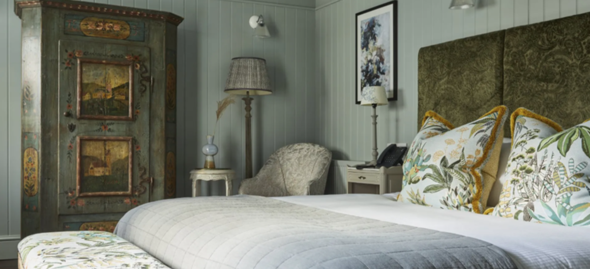 An impeccably decorated room at the Kings Arms, with olive greens and dusty blues/greys and antique furniture.
