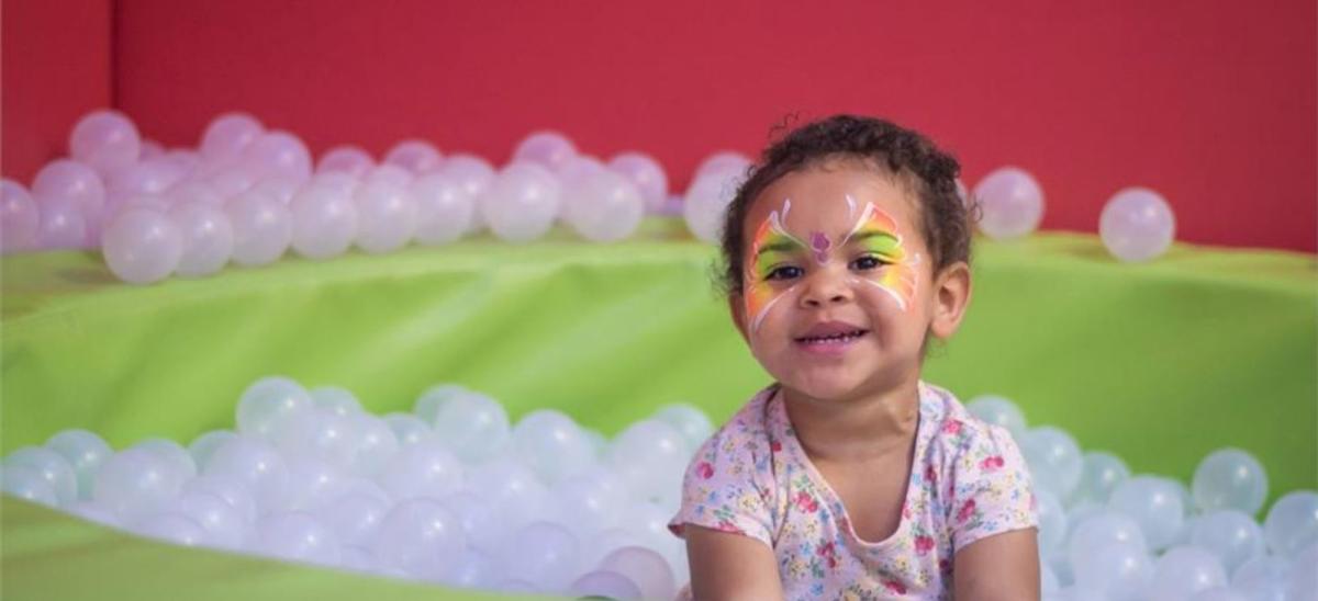 Child playing in a ball pit at Lemur Landings, Poole in Dorset