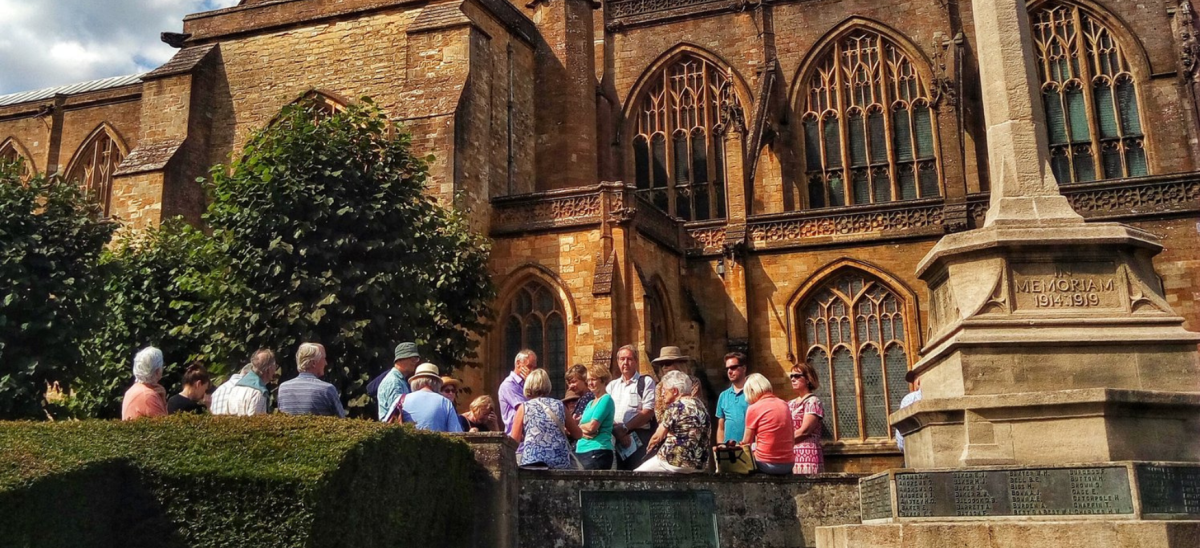 Group tour outside Sherborne Abbey