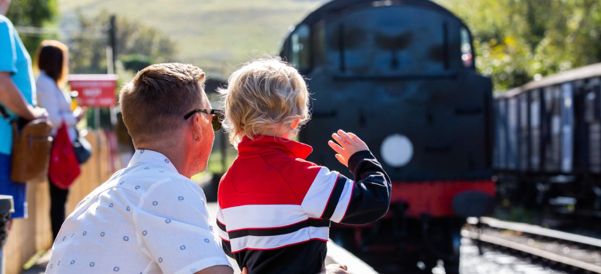 Dad and son watching the Swanage Railway