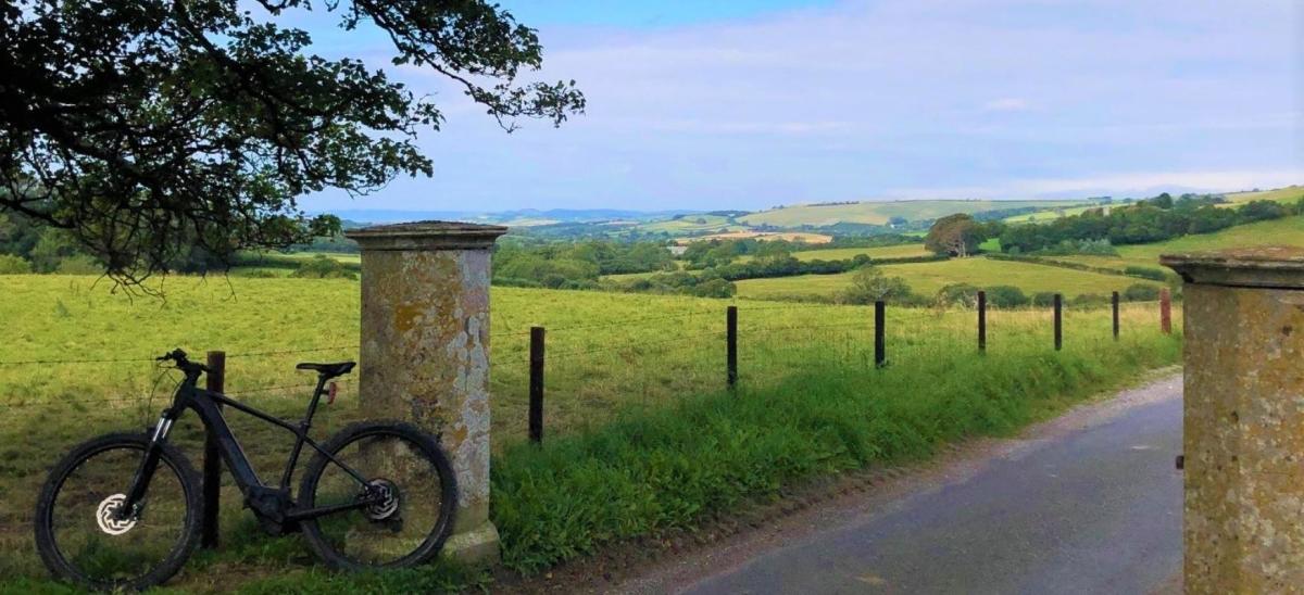 Bicycle leaning against a fence at Littlebredy village in Dorset