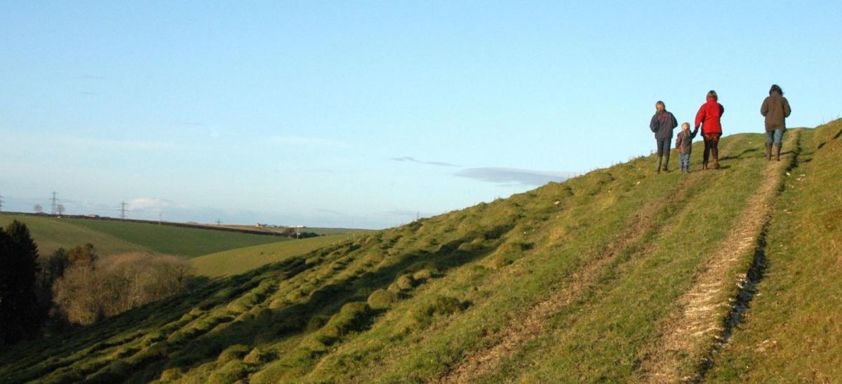 A family of four people taking a winter walk in Dorset
