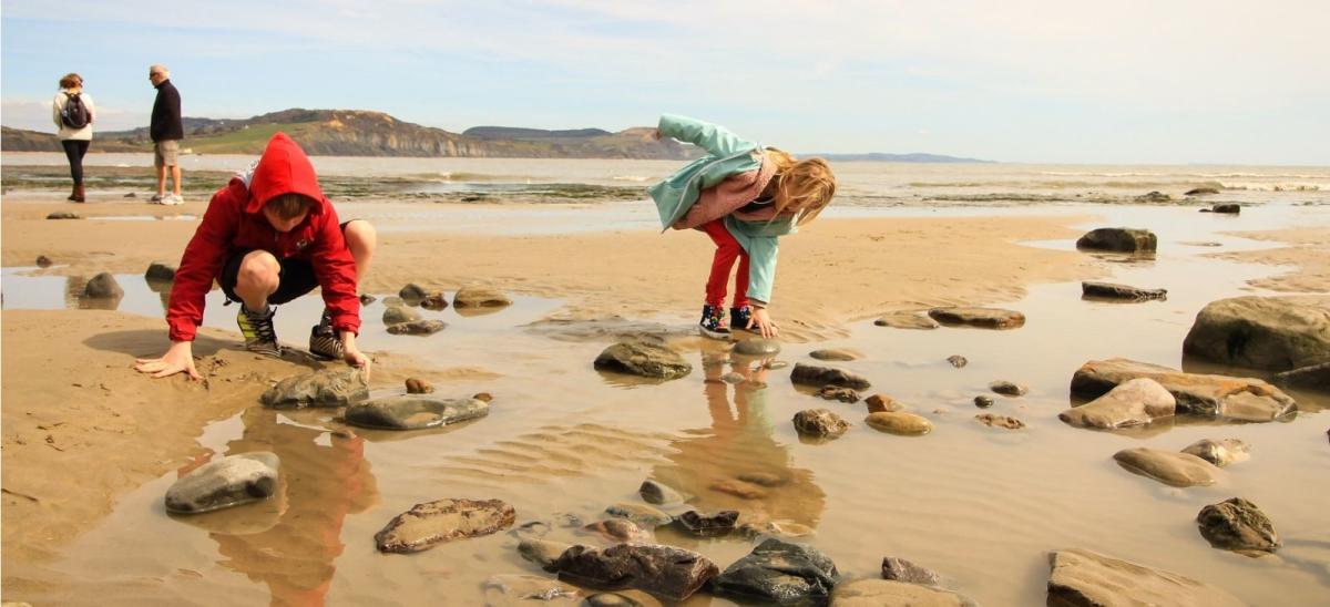 Two children fossil hunting at Lyme Regis in Dorset