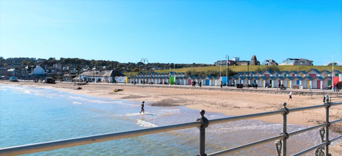 The view from Swanage Banjo Pier towards the sandy beach and beach huts