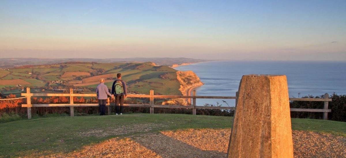 Couple overlooking the Jurassic Coast from the top of Golden Cap