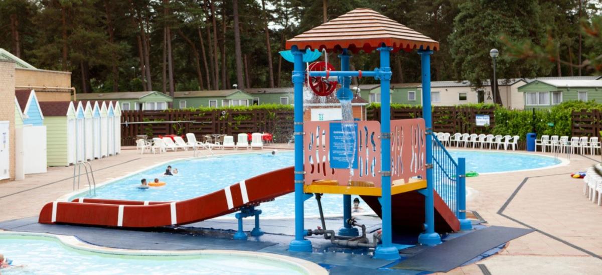 Outdoor swimming pool and slide at Sandford Holiday Park outdoor pool in Dorset