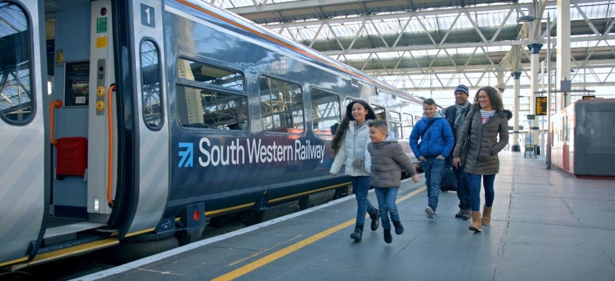 Family boarding a South Western Railway train