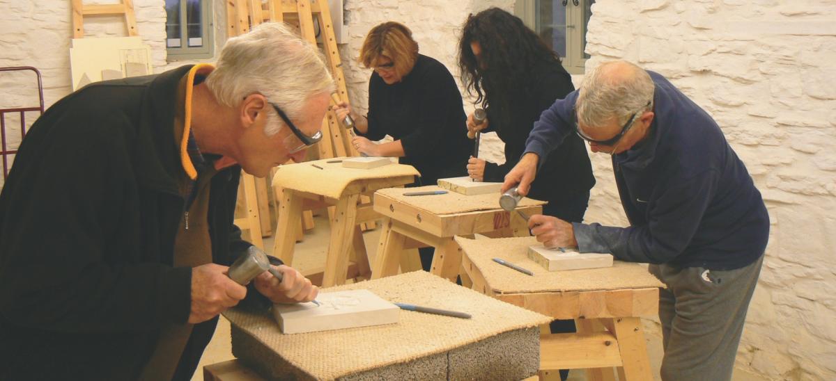 Four people stone carving at Burngate Stone Carving Centre