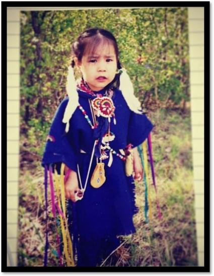 An Indigenous child dressed in regalia