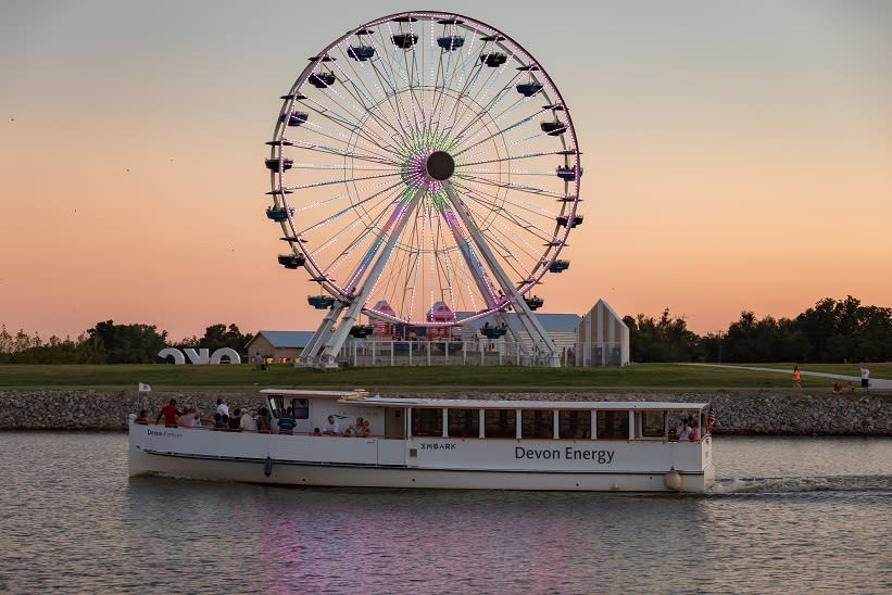 The Oklahoma River Cruise going by the Wheeler Ferris Wheel