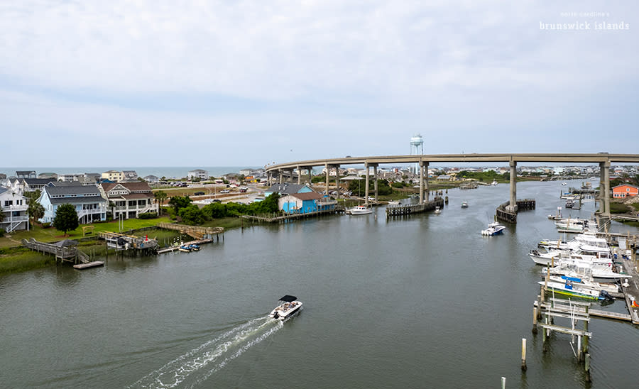 a boat traveling down the Intracoastal Waterway in Holden Beach