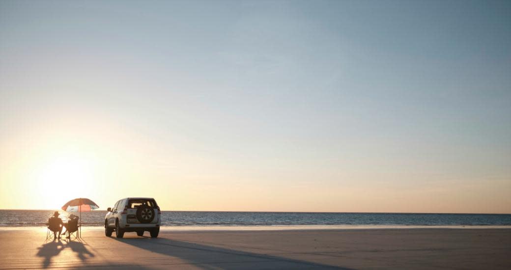 People and car on Cable Beach Broome