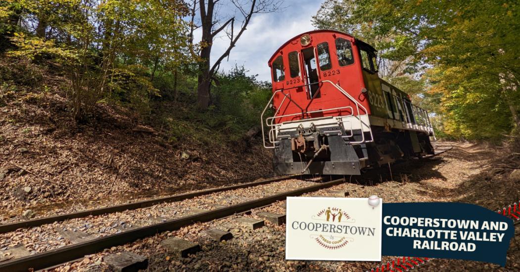 An image of a red train on tracks in the woods, with the text Cooperstown and Charlotte Valley Railroad beneath it