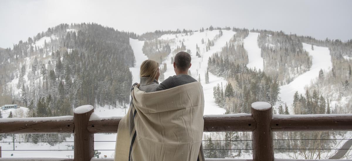 Couple wrapped in a blanket on Flagstaff deck at Stein Eriksen Lodge