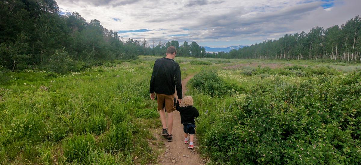 Father and son walking on a hiking trail