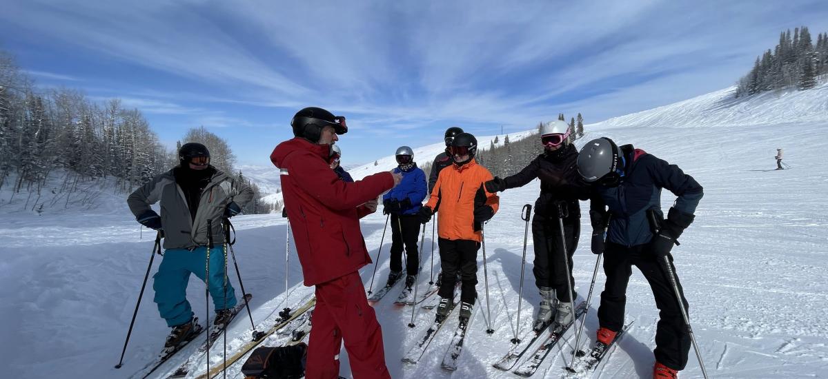 Group standing on their skis with guide of the Silver to Slopes tour.