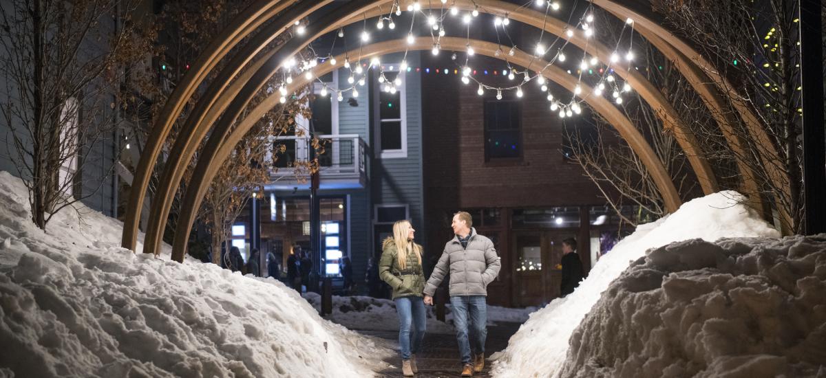 Couple under lighted arch on Main Street