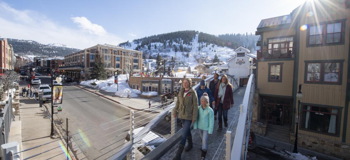 Family walking across bridge on Lower Main Street