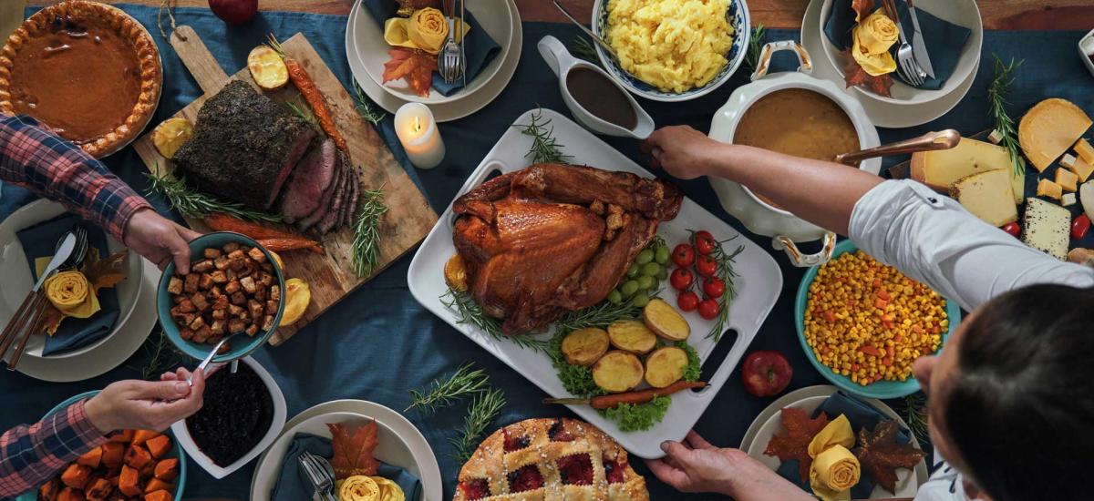 A turkey is served to a table surrounded by other Thanksgiving dishes in Park City, UT