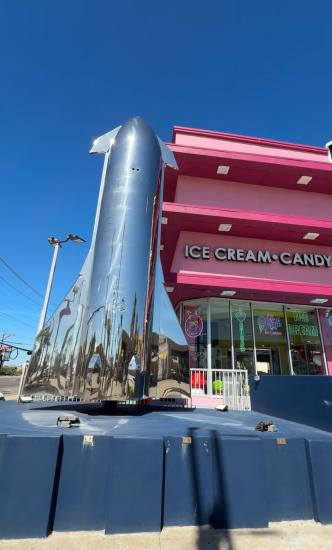Large chrome rocket located outside candy shop