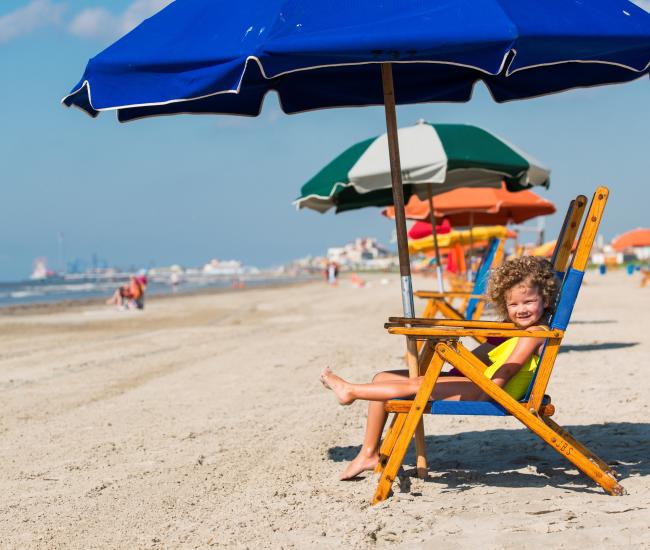 Kids enjoying the beach chairs along Stewart Beach in Galveston, TX