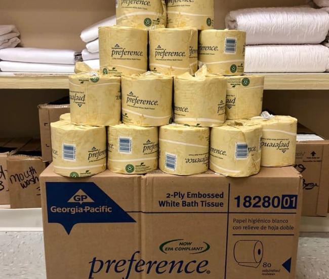 stacks of toilet paper on top of a box