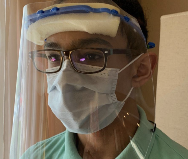 man wearing plastic face shield