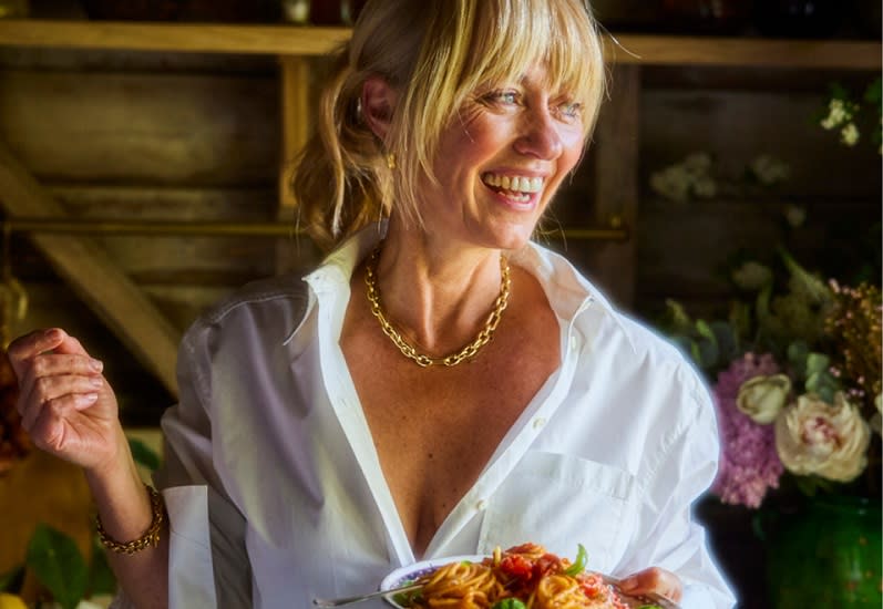 Clodagh McKenna smiles whilst holding a plate of food