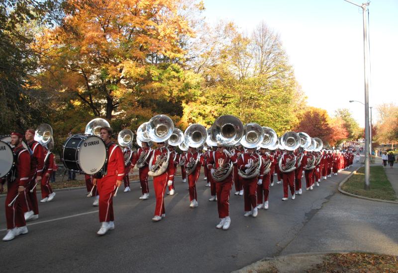 Marching band in uniform and playing their instruments at the IU Homecoming Parade