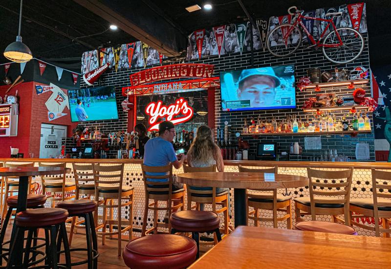 A couple sitting at the bar at Yogi's