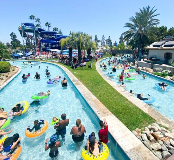 Image of a lazy river at Knott's Soak City. People can be seen floating in the river innertubes.