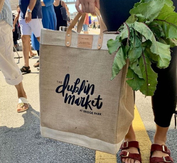 Canvas tote bag filled with leafy greens