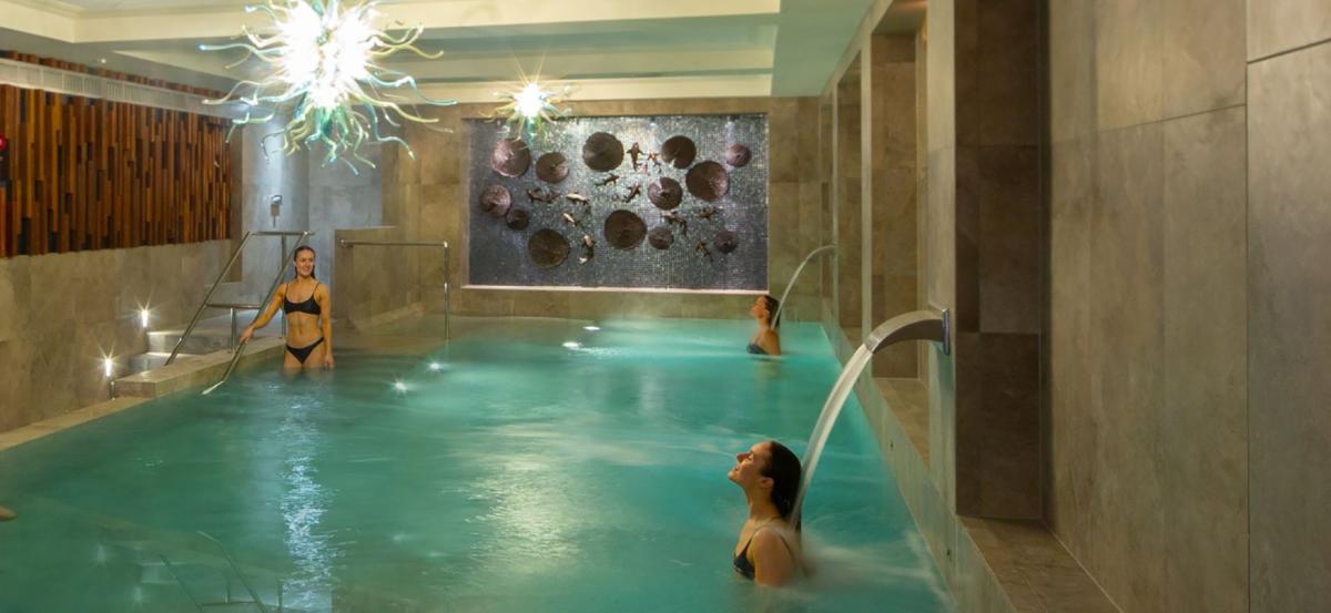 Two people in the Hydrotherapy Pool at Monart Spa, Poundbury in Dorset