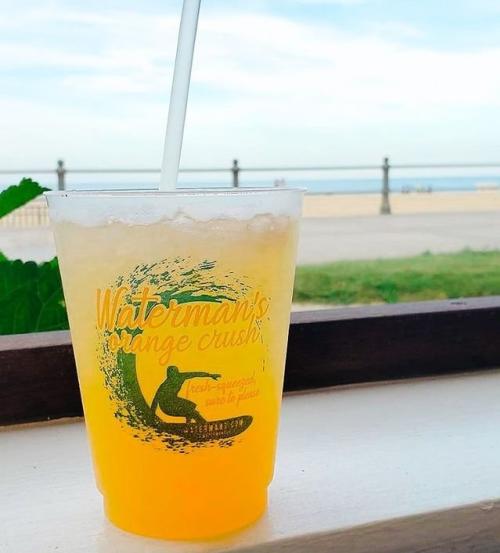 A drink sitting on a windowsill 