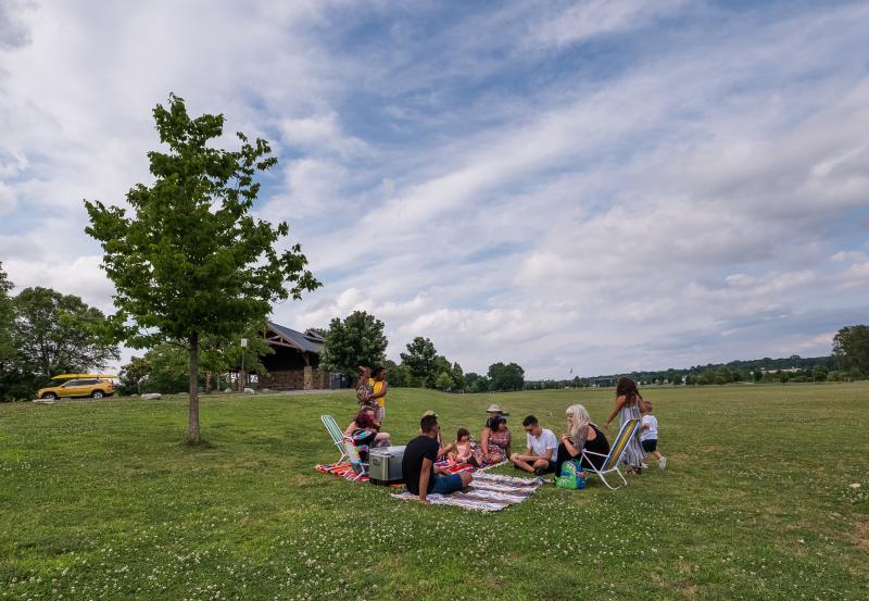 group of people having a picnic in a park