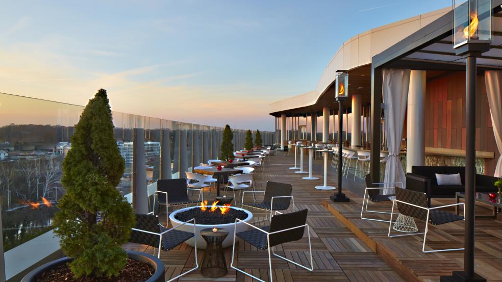 The view from eight stories up on the patio at VASO Rooftop Lounge with seating and firepits.
