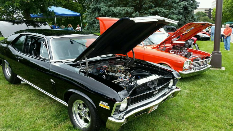 Two cars with the hood open at the Arthritis Car Show