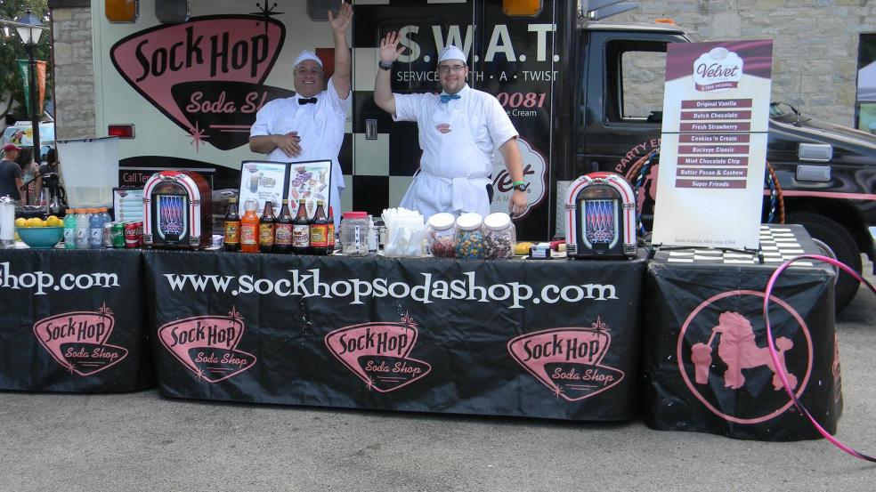 Sock Hop Sodas stand waving to the crowd at the Historic Dublin Street Bazaar