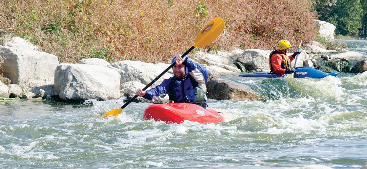 Kayakers paddle the Marge Cline Whitewater Course