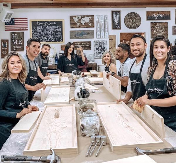 People crafting signs at Board and Brush