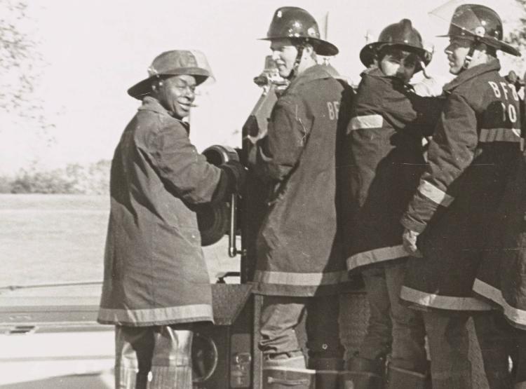 Cicero Williams and fellow firefighters stand in uniform looking at the camera